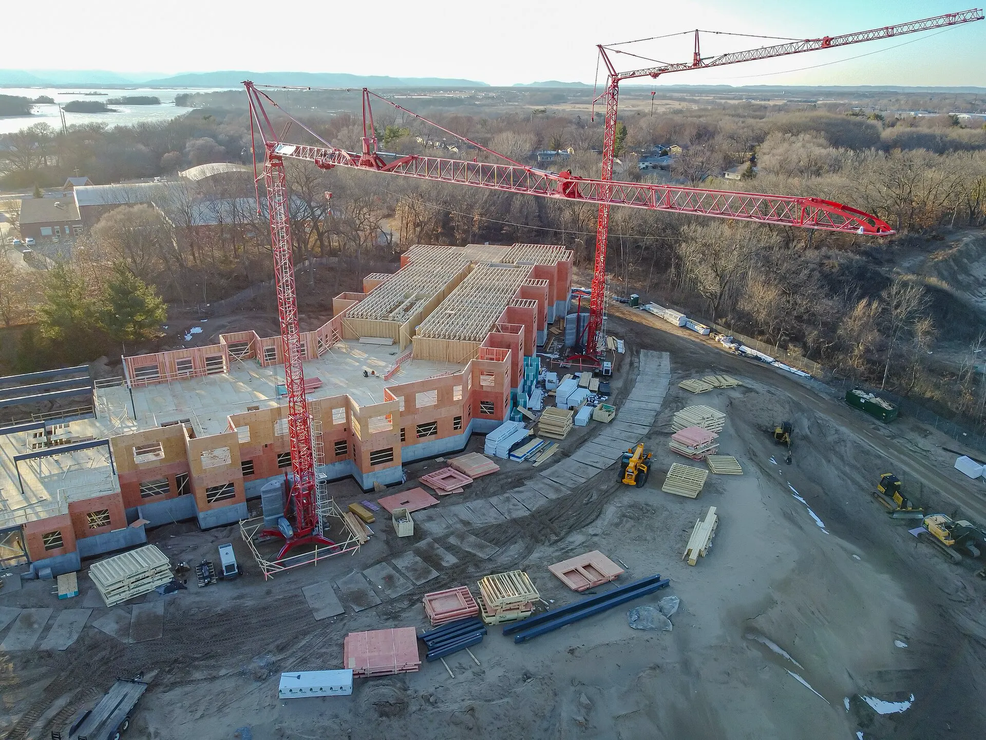 Aerial view of a large building site with several tower cranes