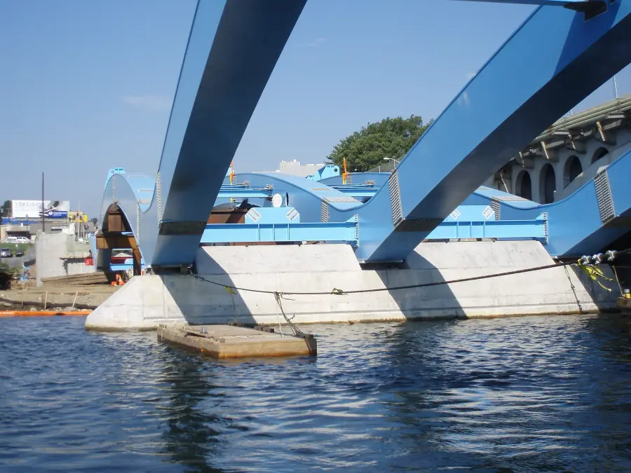 The underside of a new arch span at the waterline.