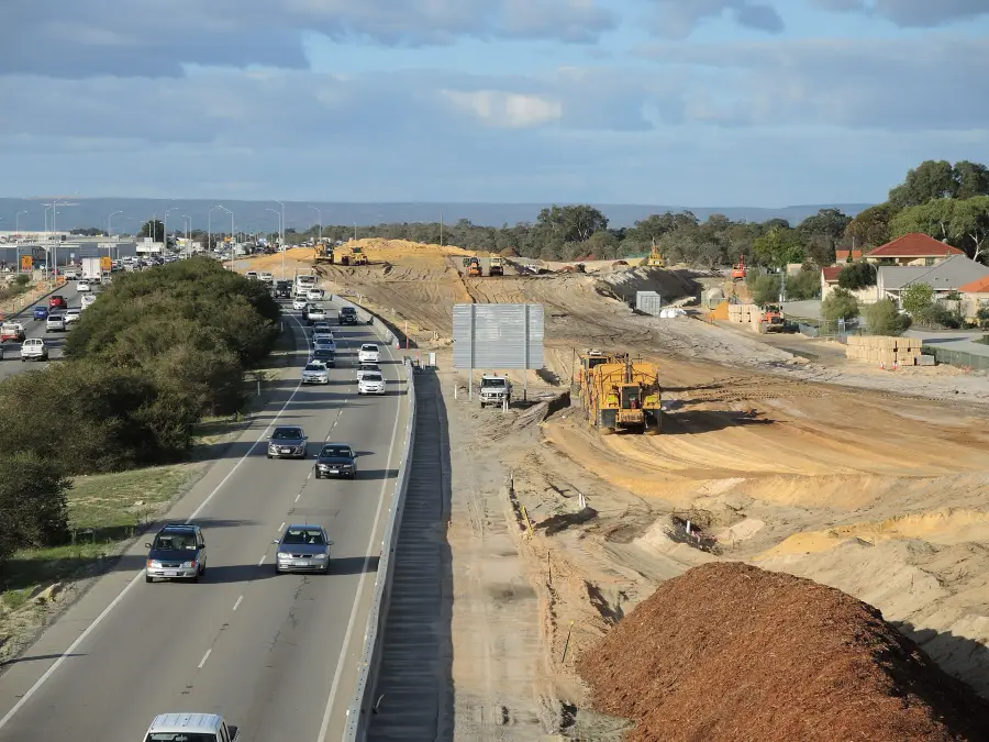 Earthwork and new lanes alongside live highway traffic.
