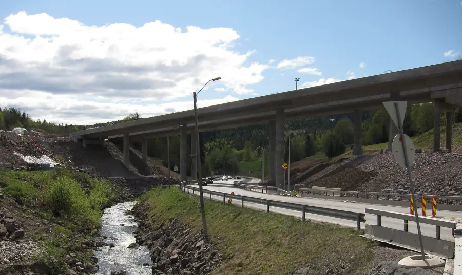 A completed overpass above a creek corridor.