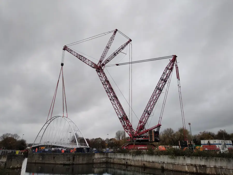 A large lattice-boom crawler crane assembled on site.