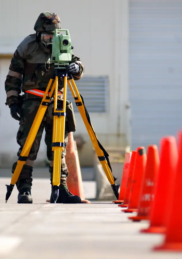 Survey tripod set up beside traffic cones